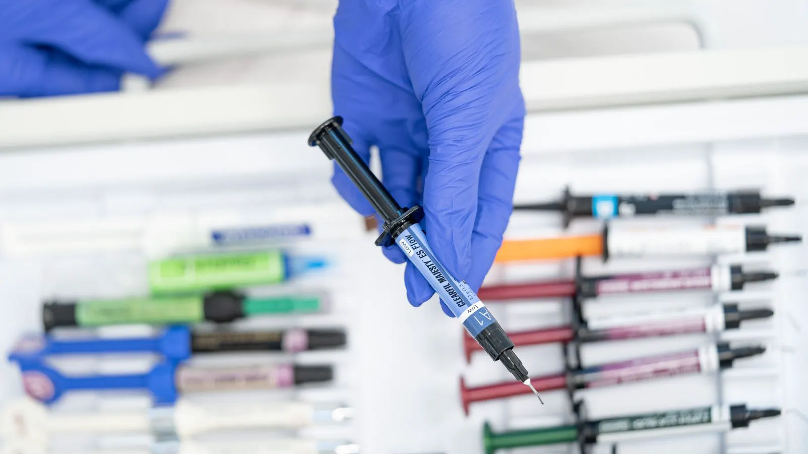 Close up of a printed resin certificate next to a clear plastic medical component.