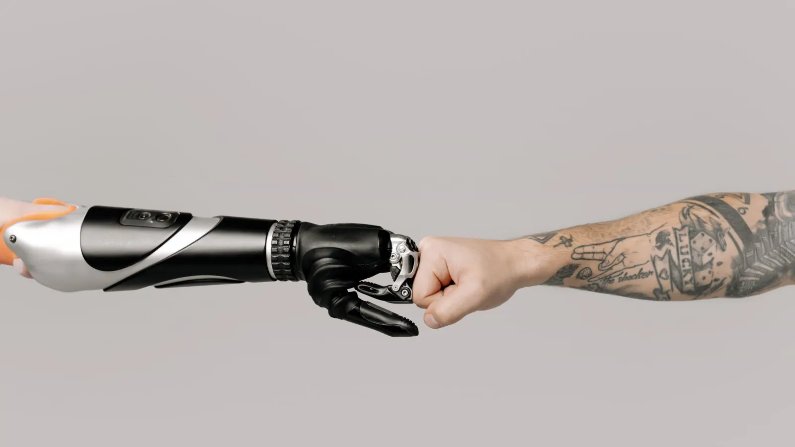 A robotic arm inspects molded plastic parts on an assembly line