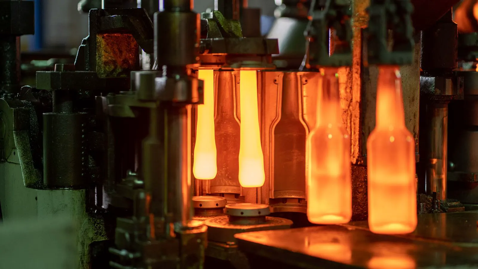 Close view of an injection molding machine producing plastic electronics housings