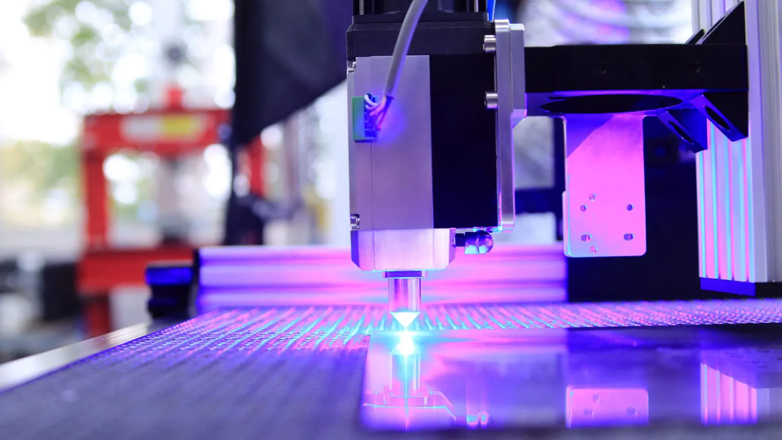 A close-up view of a modern injection molding machine in operation.