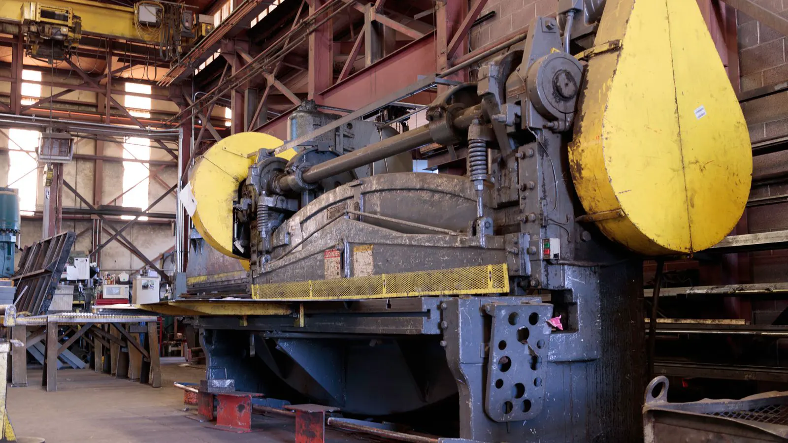 A modern injection molding machine running in a clean factory production area.