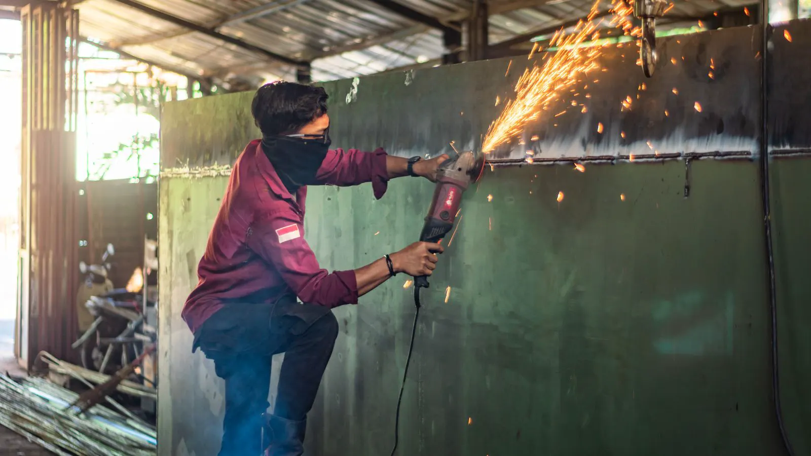 A welder adjusting the torch angle on a thin metal joint