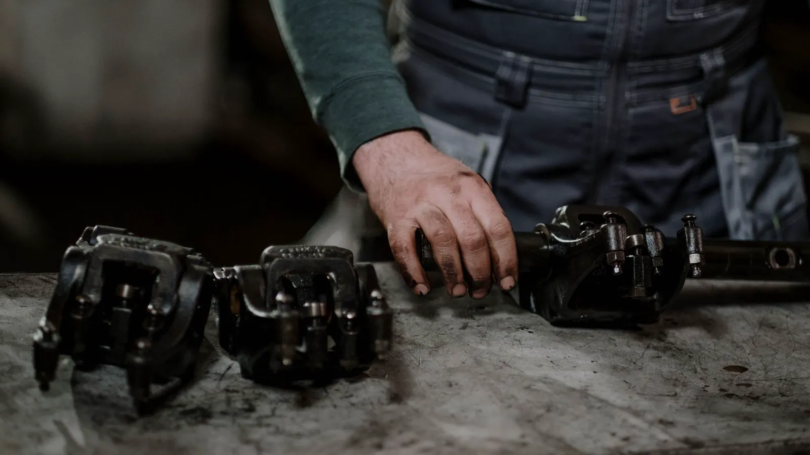 An inspector uses calipers to check dimensions of a sheet metal assembly