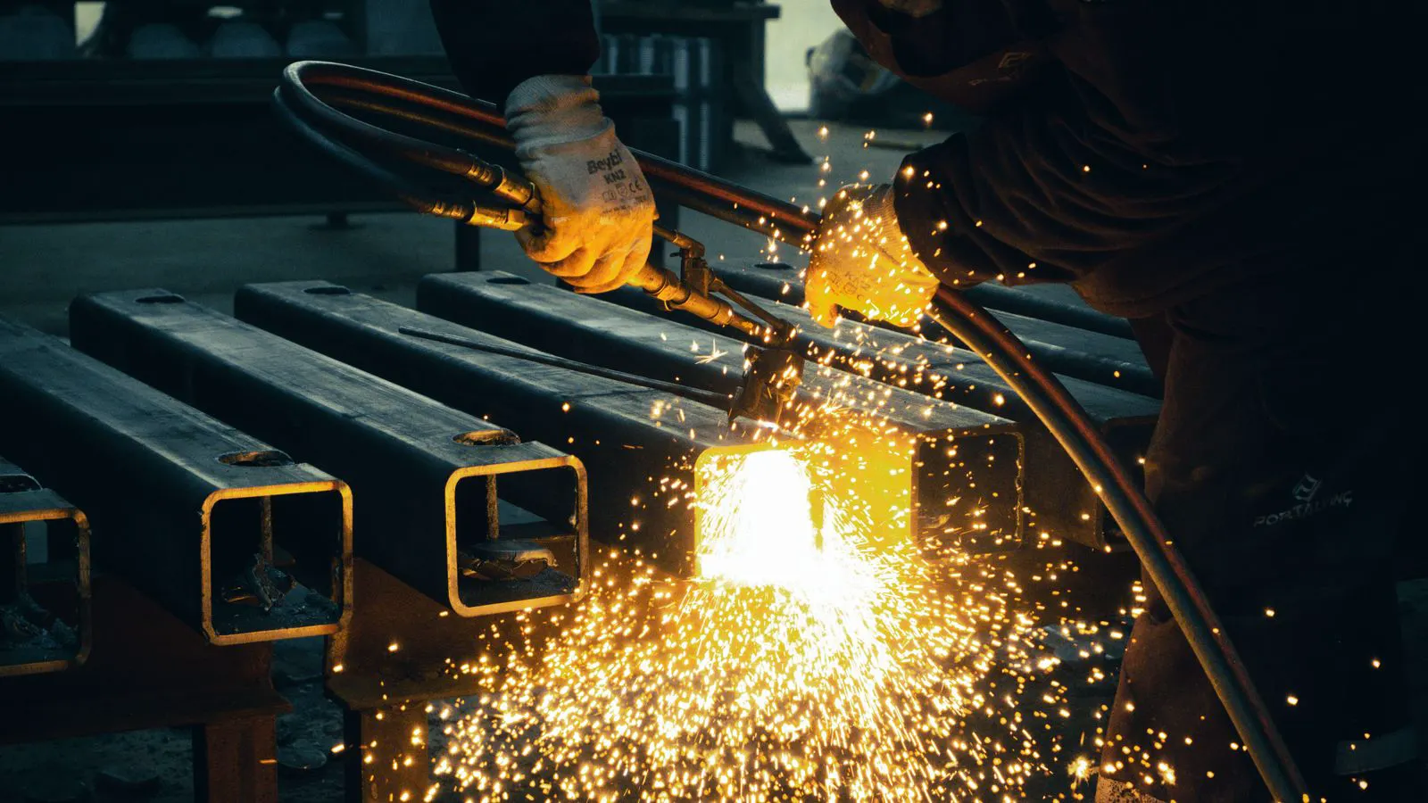 Close up of a welder applying gas shield to a metal joint