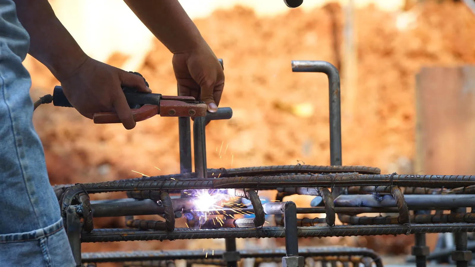 Technician uses a gauge to measure a finished weld joint.