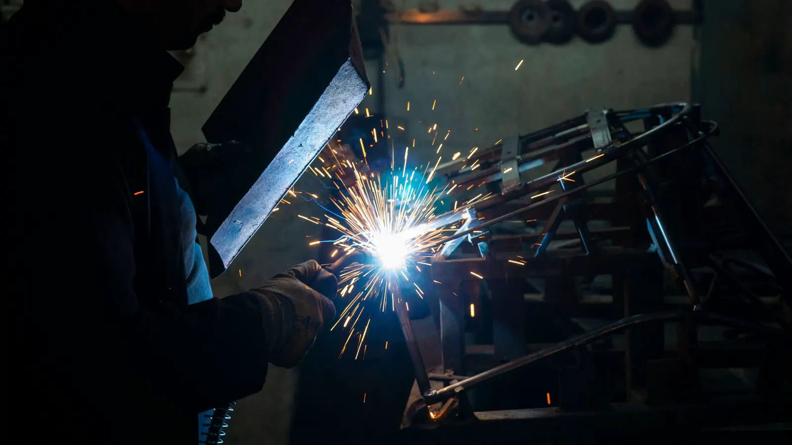 A torch preheating a thin steel sheet before a weld pass.