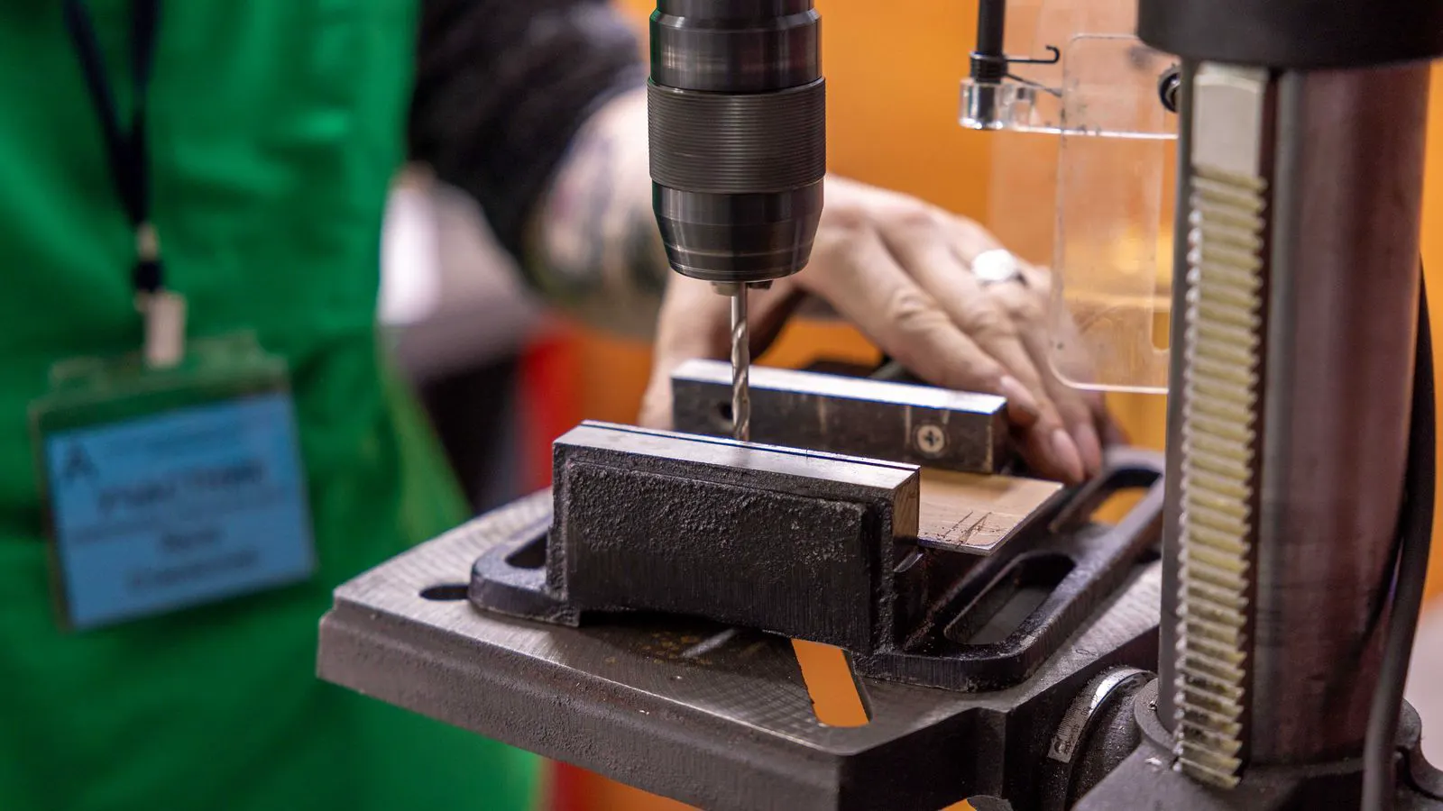 A CNC bending press working on a sheet metal part in a workshop.