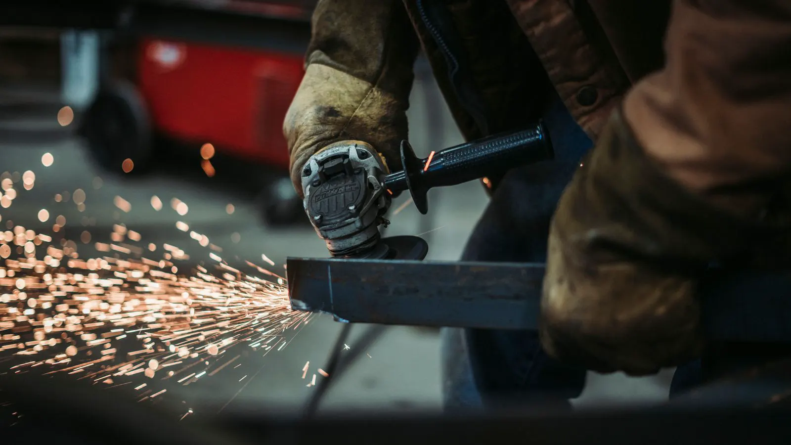 Operator adjusting press brake tooling and checking sheet metal angle