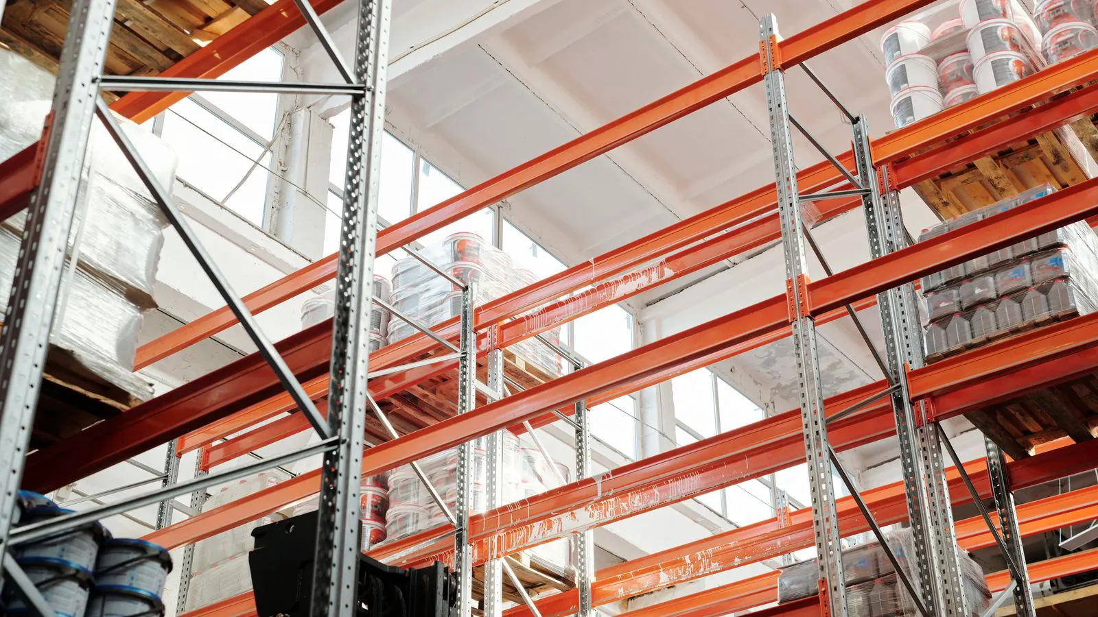 Stacks of steel coils stored in an industrial warehouse.