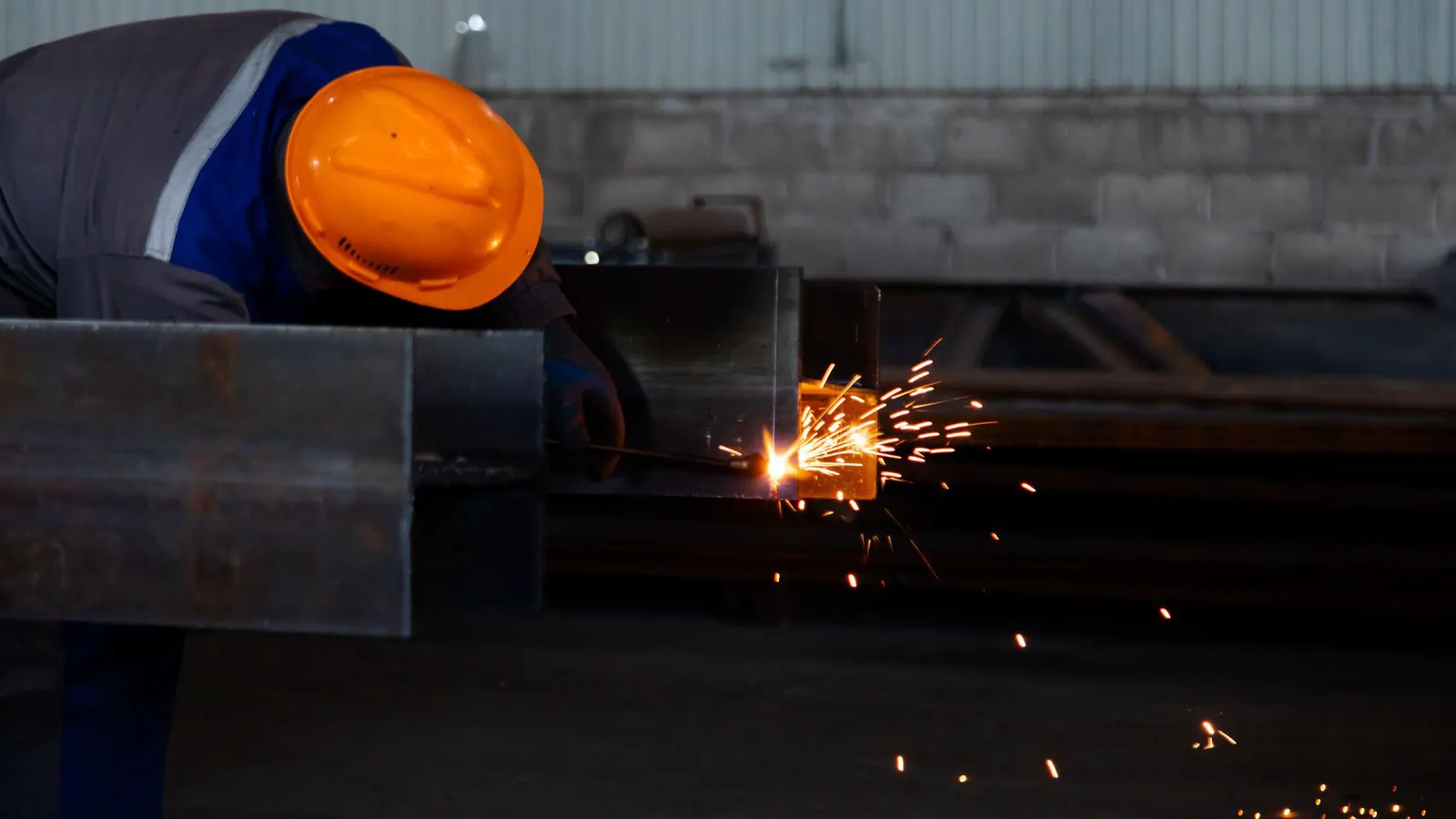 Welder working on a thin sheet metal panel