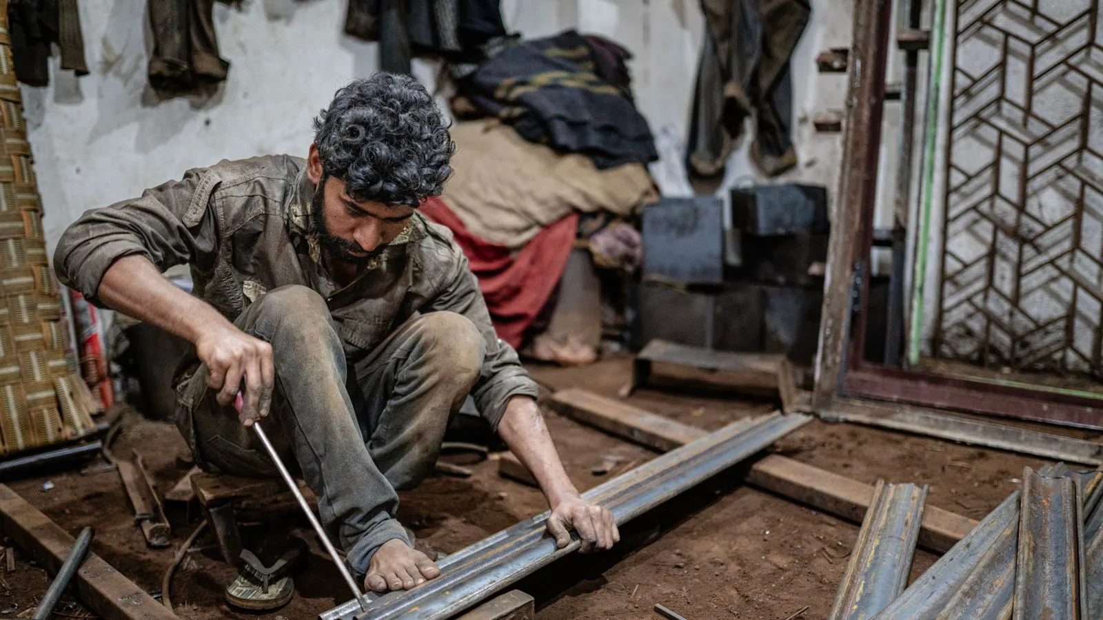 Engineer reviewing sheet metal drawings on a factory floor