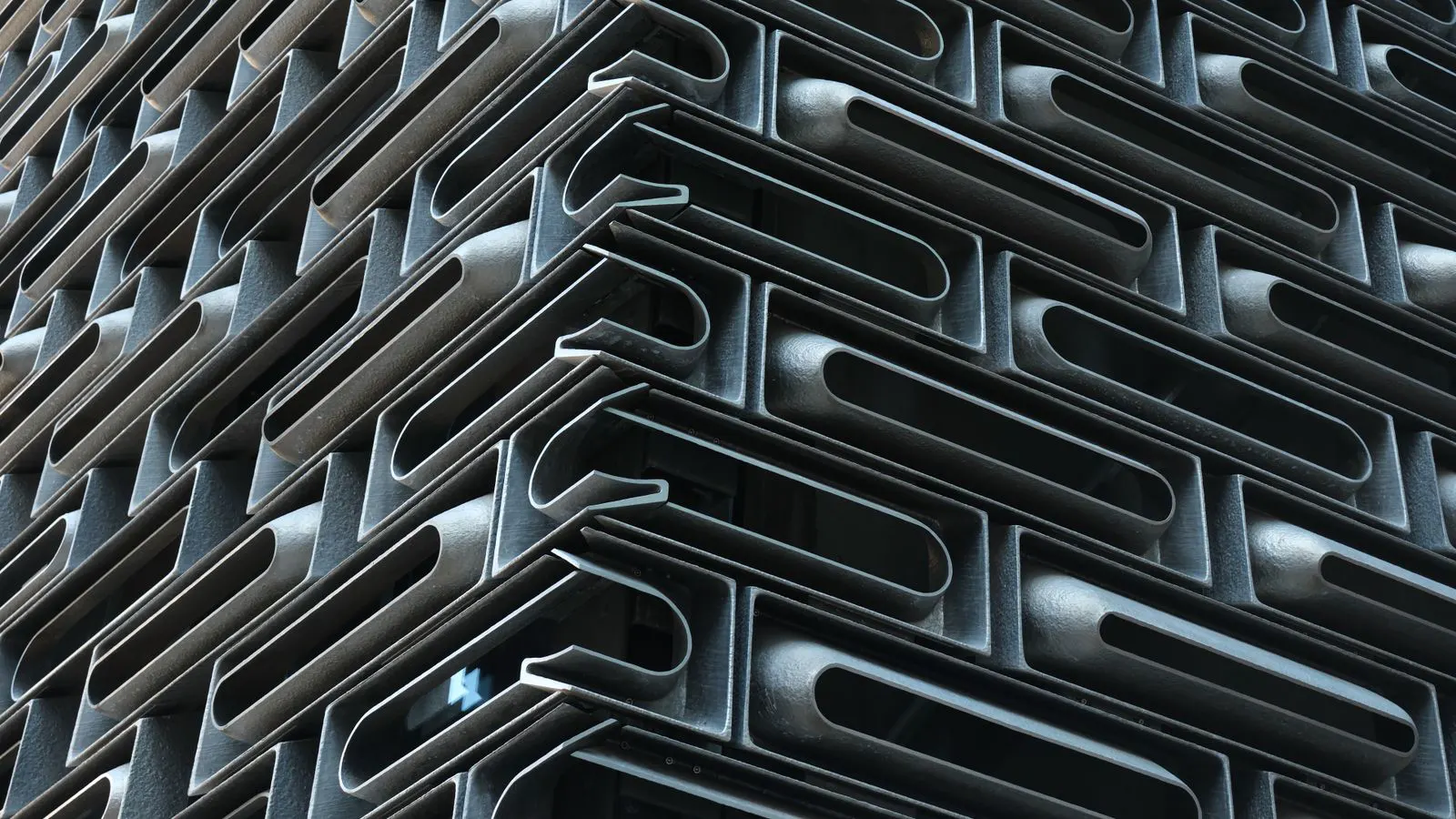 A sheet metal bending machine forming a flat plate into an angle