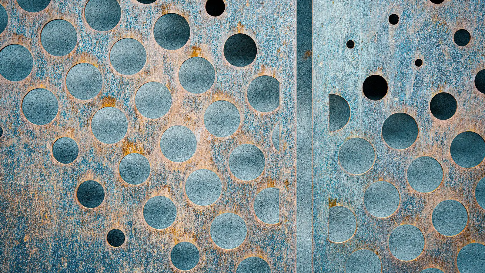 Two metal sheet stacks showing zinc coating and stainless finish