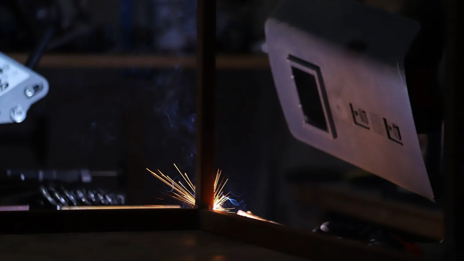 Close-up of a steel sheet with measurement tools and an inspection checklist