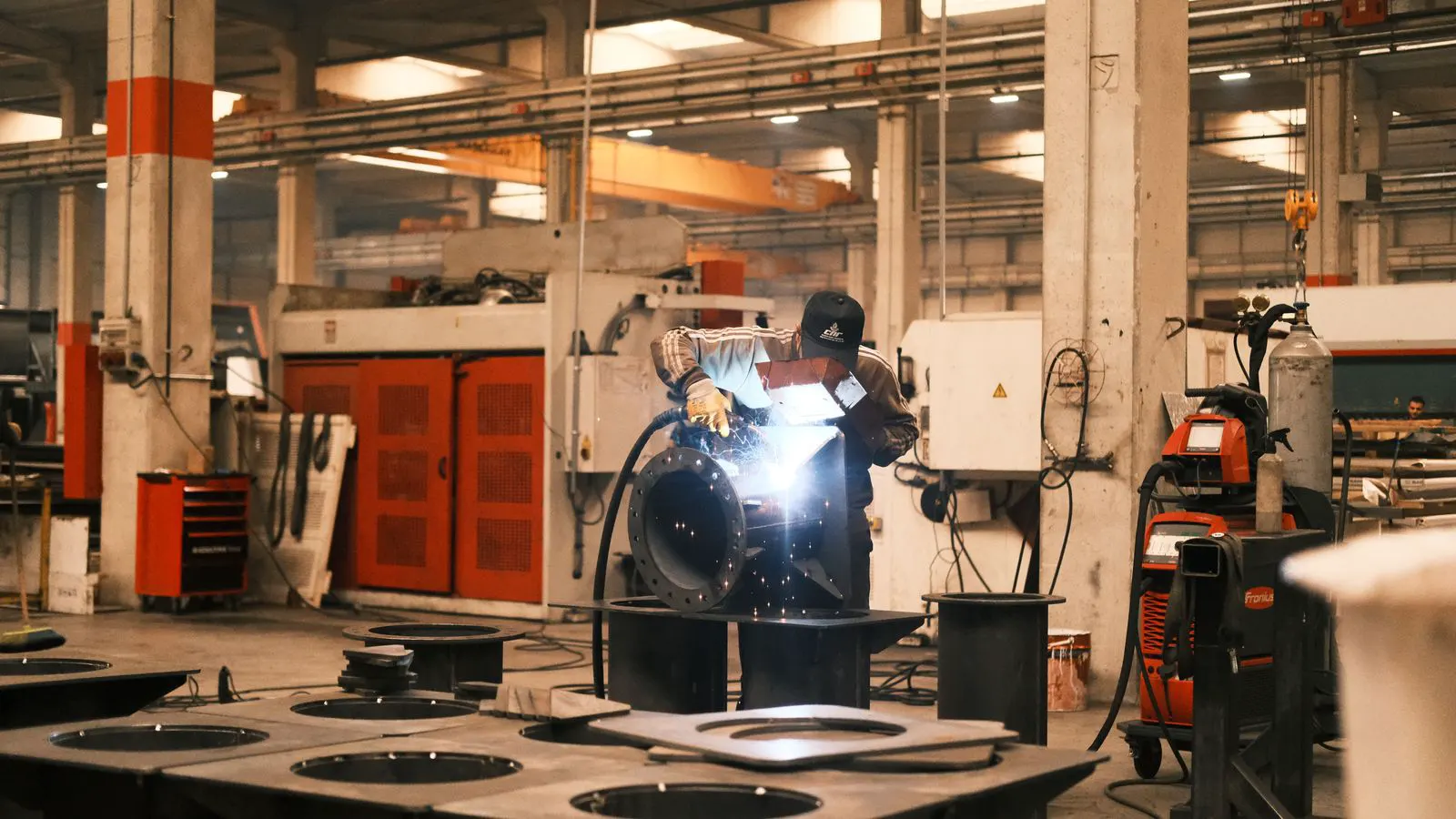 Industrial spot welding machine clamping two thin steel plates together