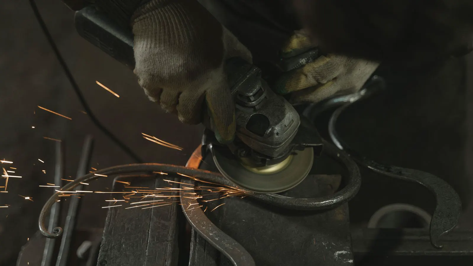 A sheet metal part emerging from a press brake die.