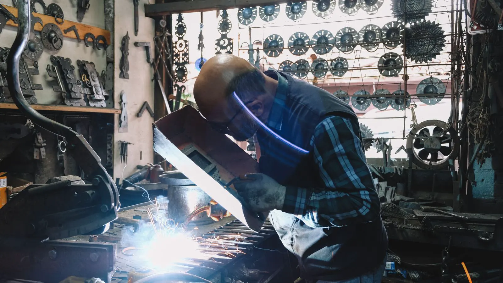 A metal fabrication shop floor with sheet metal parts and tools
