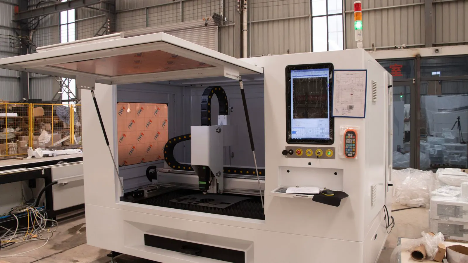 Close view of a CNC bending machine processing a sheet metal panel