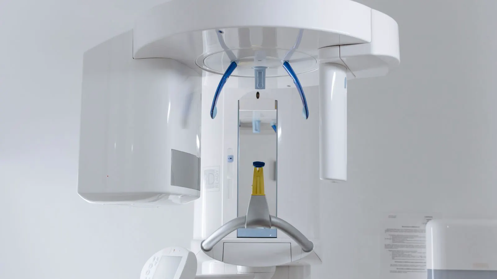 A large industrial x-ray machine positioned near a stack of sheet metal panels.