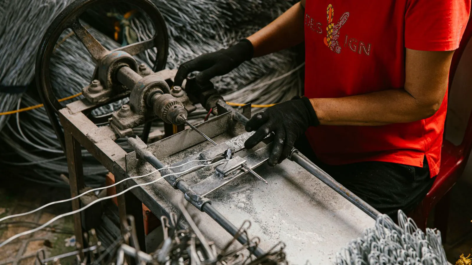Operator adjusting a mechanical bending machine in a fabrication shop