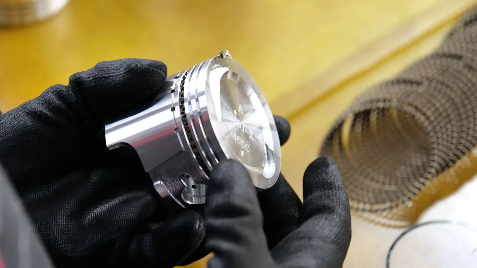 Engineer inspecting a finished sheet metal part edge quality