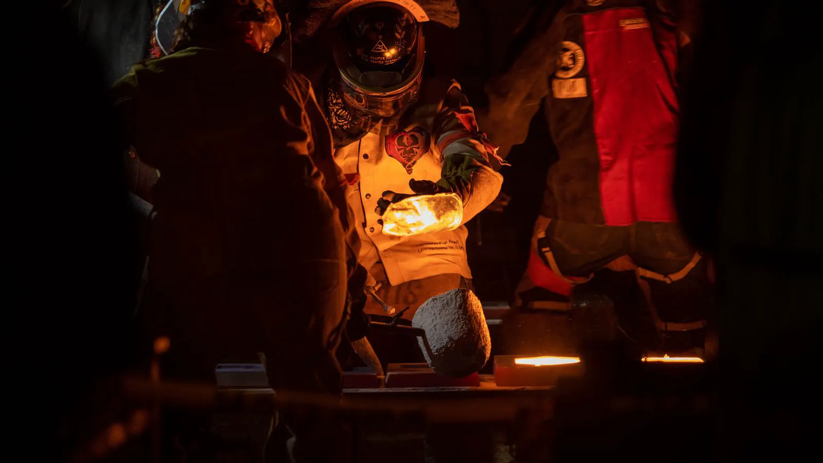 A large die casting machine injecting molten metal into a steel die.