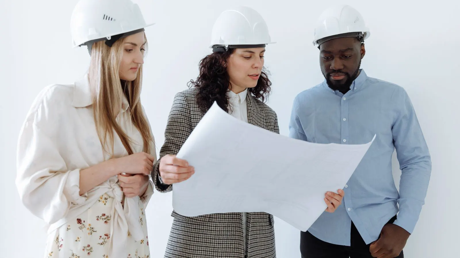 An engineer reviews technical drawings for a die casting project on a workbench.