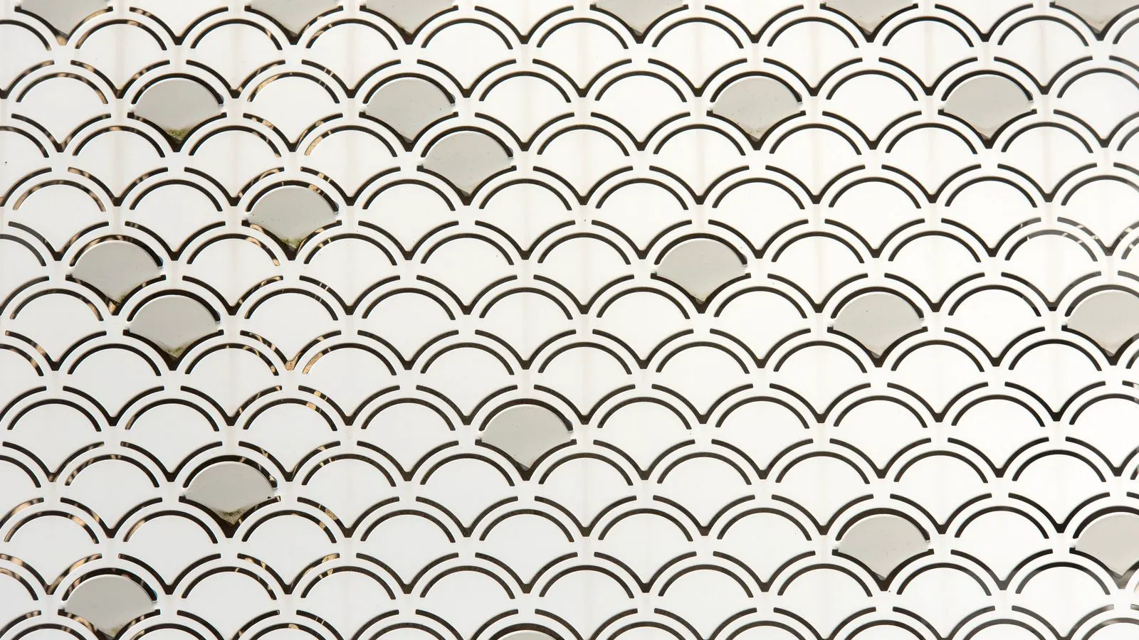Close up view of a metal stamping die with multiple punches in a workshop setting