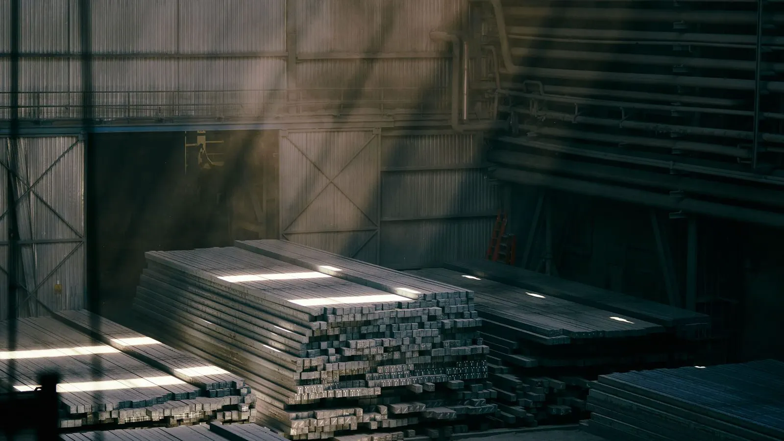 A neat stack of flat steel sheets in a processing area