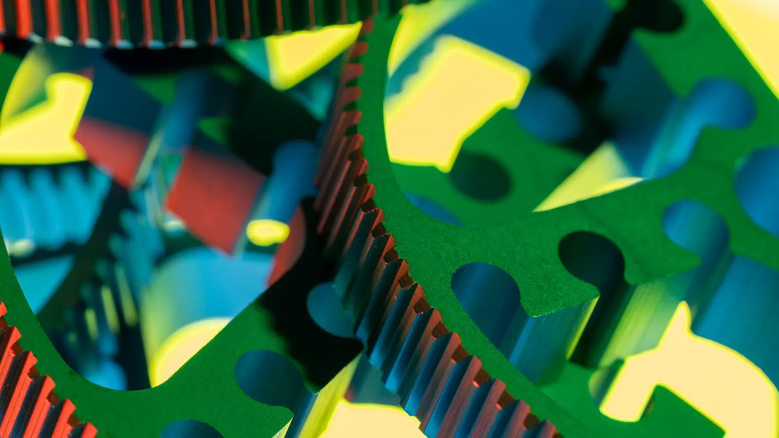 Rows of small stamped metal parts on a factory table.