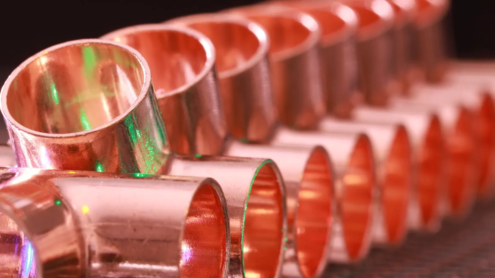 Quality engineer inspecting stamped metal parts at a workbench