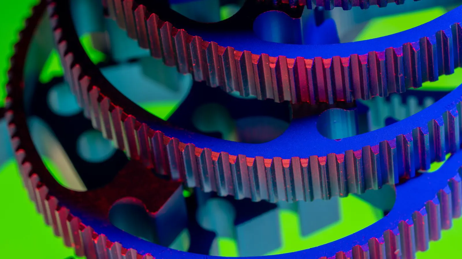 A worker inspecting a stack of stamped metal brackets on a production line