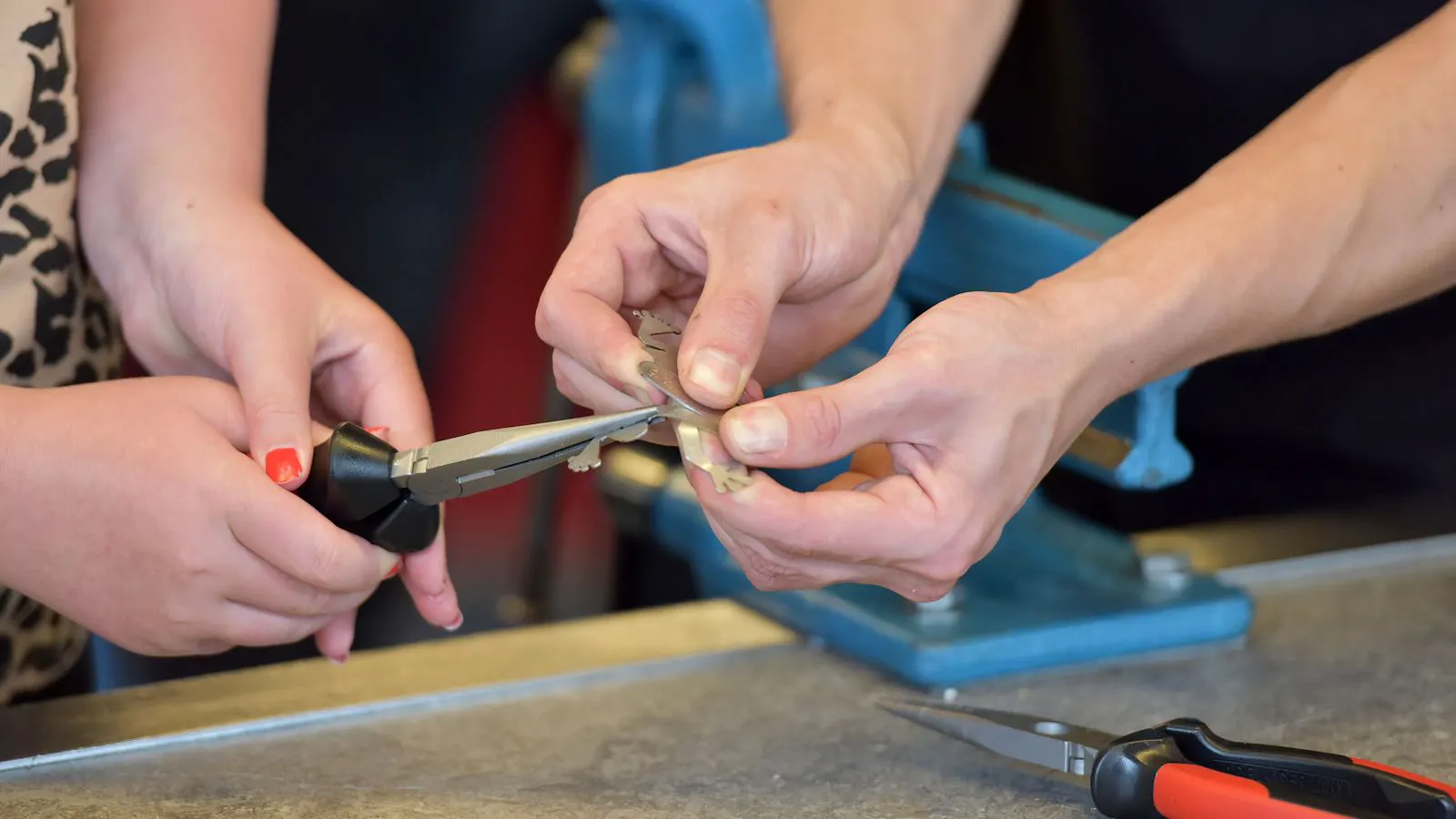 An inspector using a dial indicator to check a stamped metal bracket