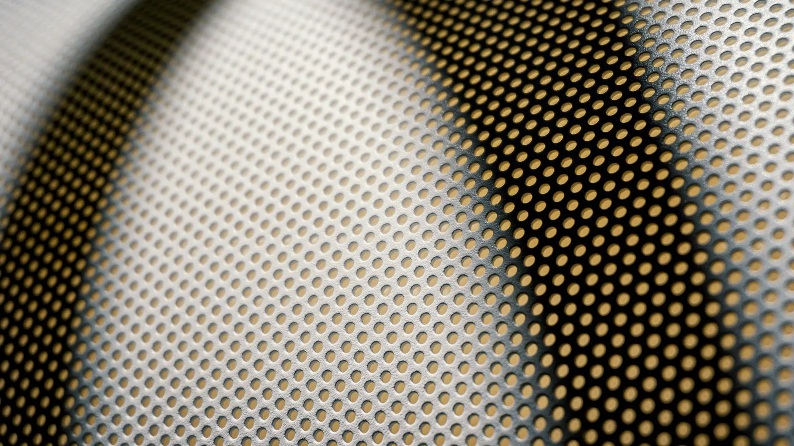 A close view of an aluminum sheet being shaped by a mechanical stamping press die