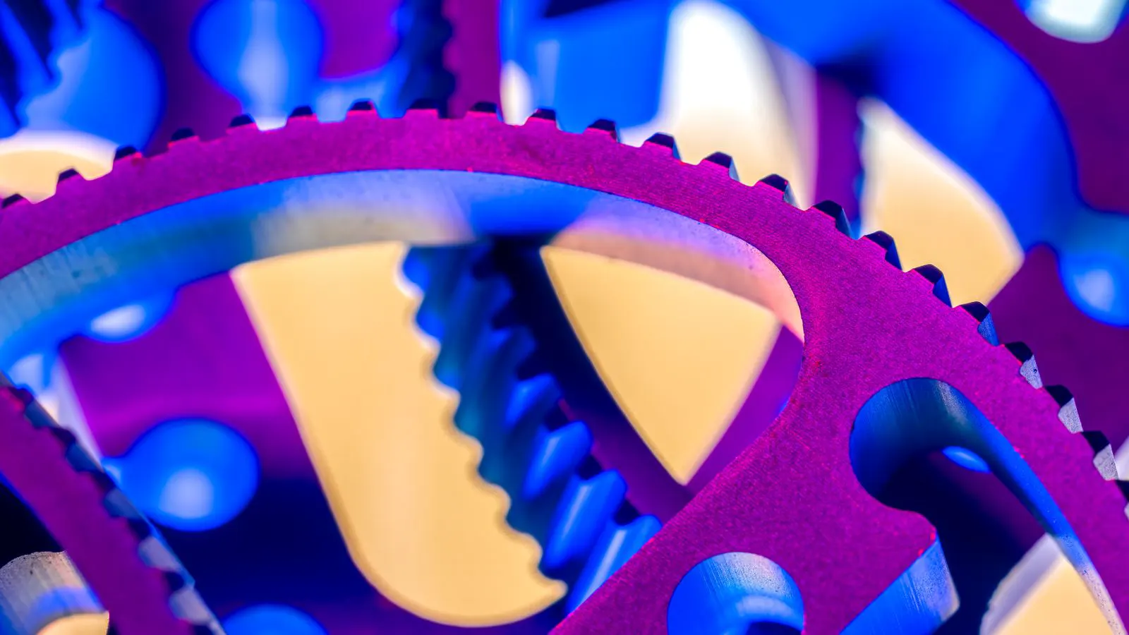 Close-up view of stamped metal parts next to a steel die