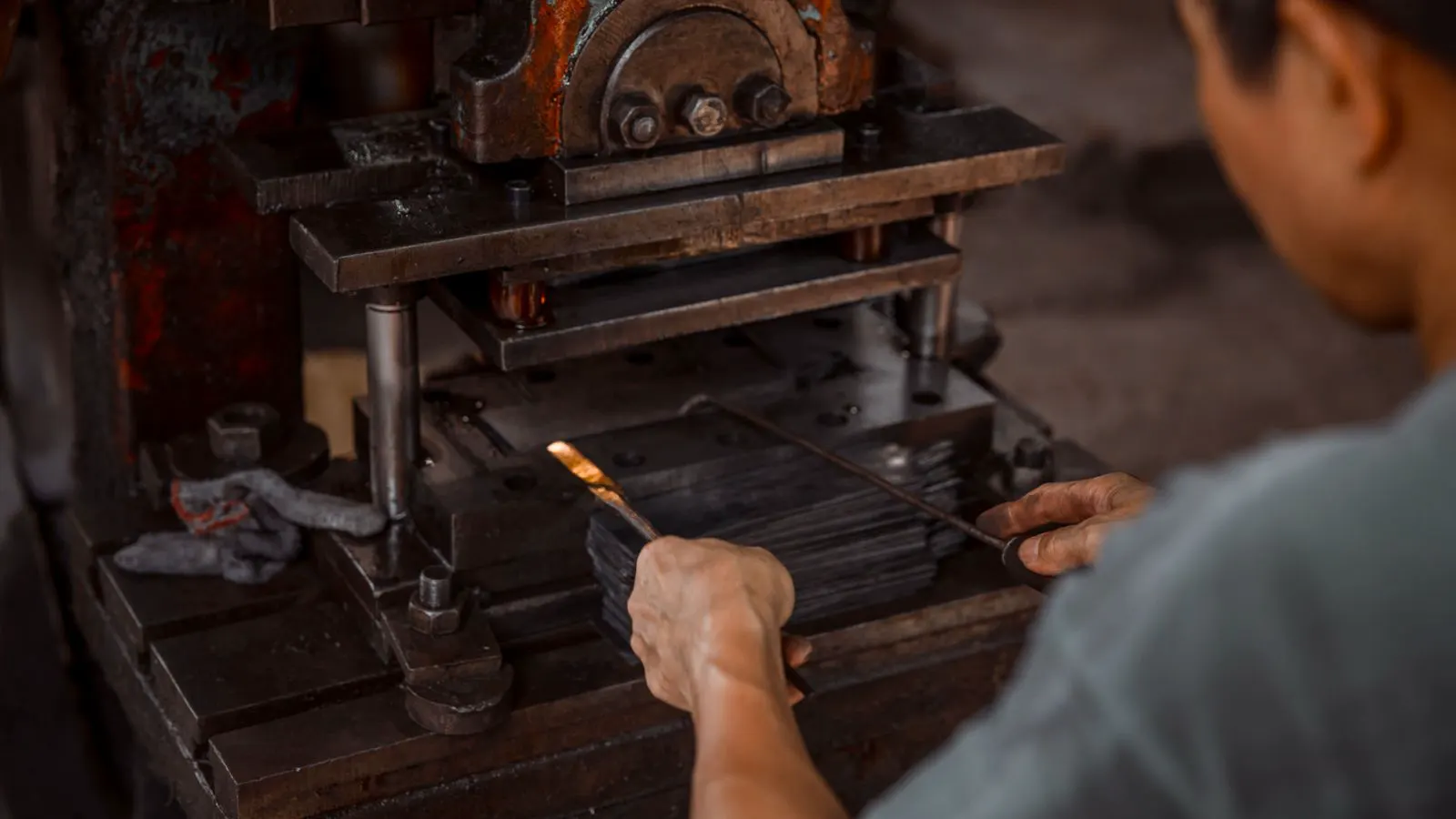Close up of hardened steel die components on a workbench.