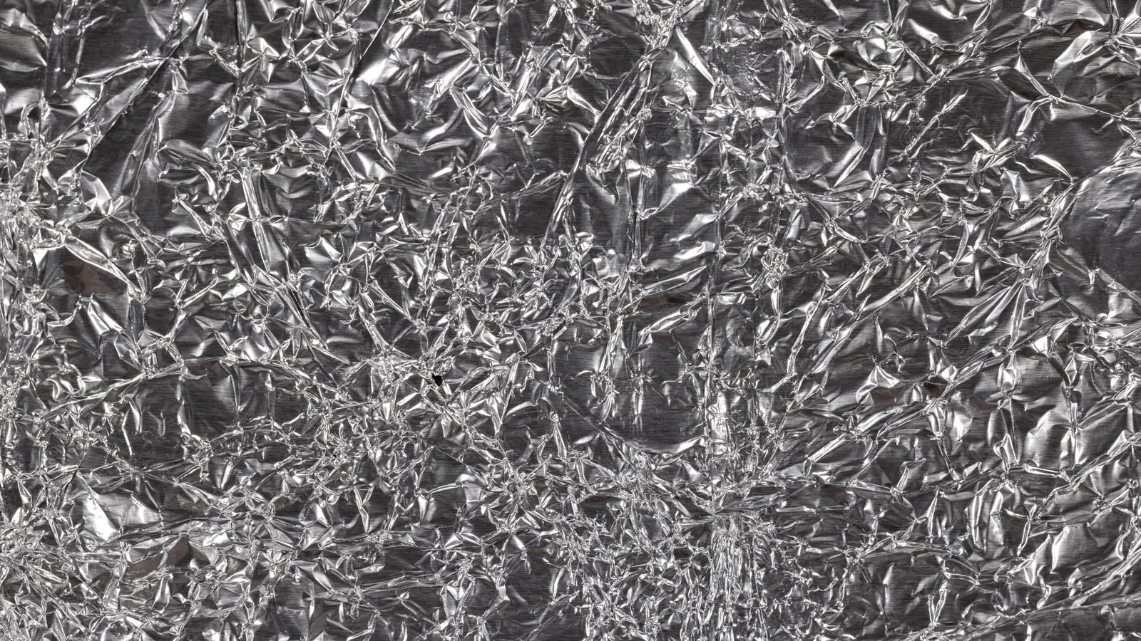 A metal stamping press forming a sheet of aluminum alloy.