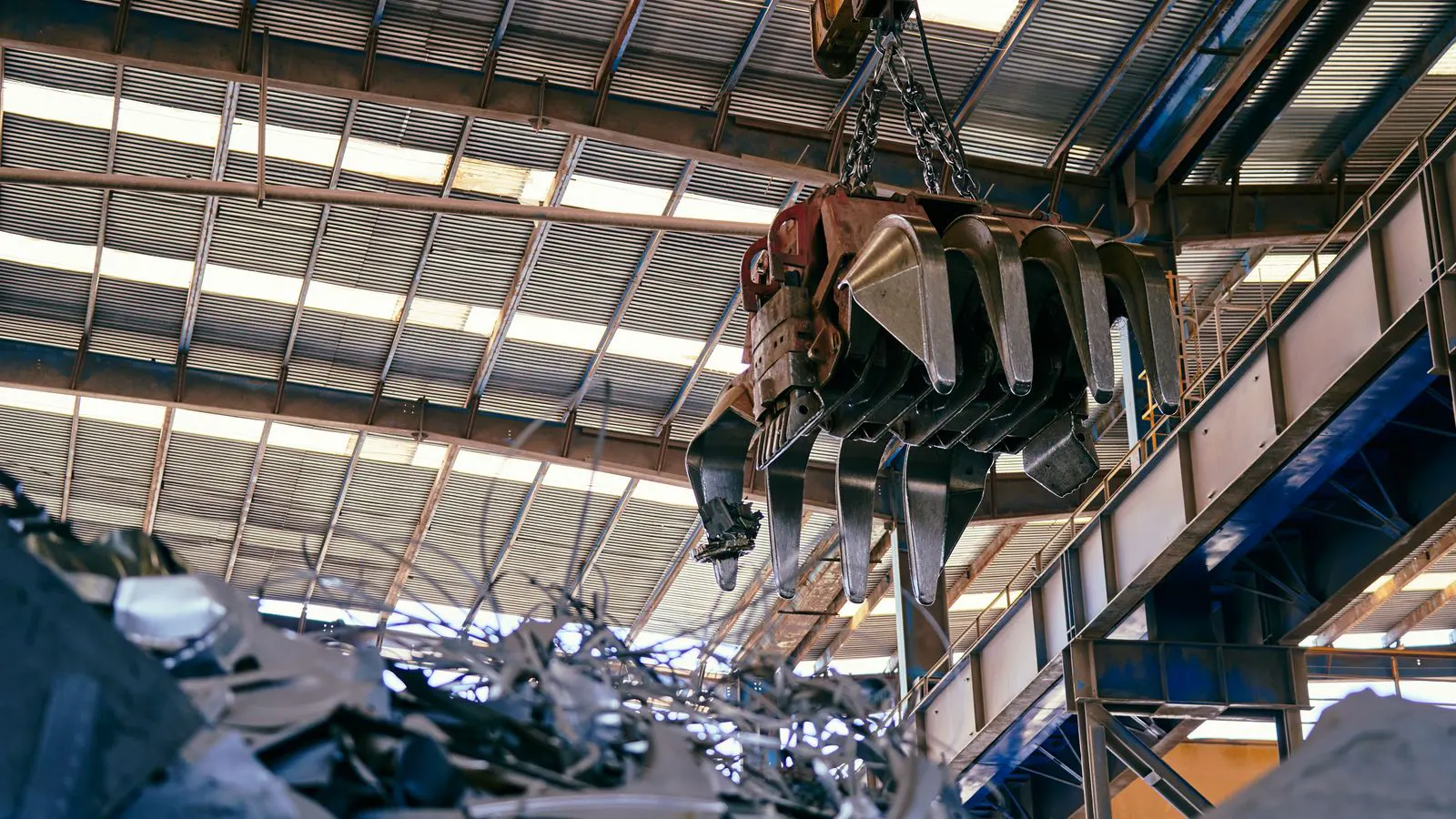 A high-speed press producing metal parts on a factory floor
