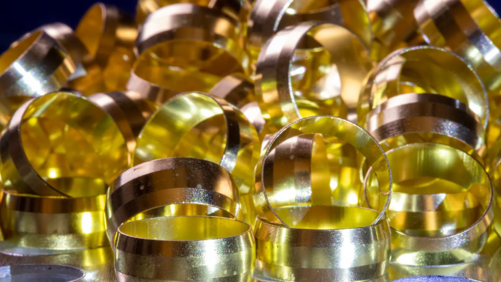 A metal stamping factory floor with presses and raw material coils.