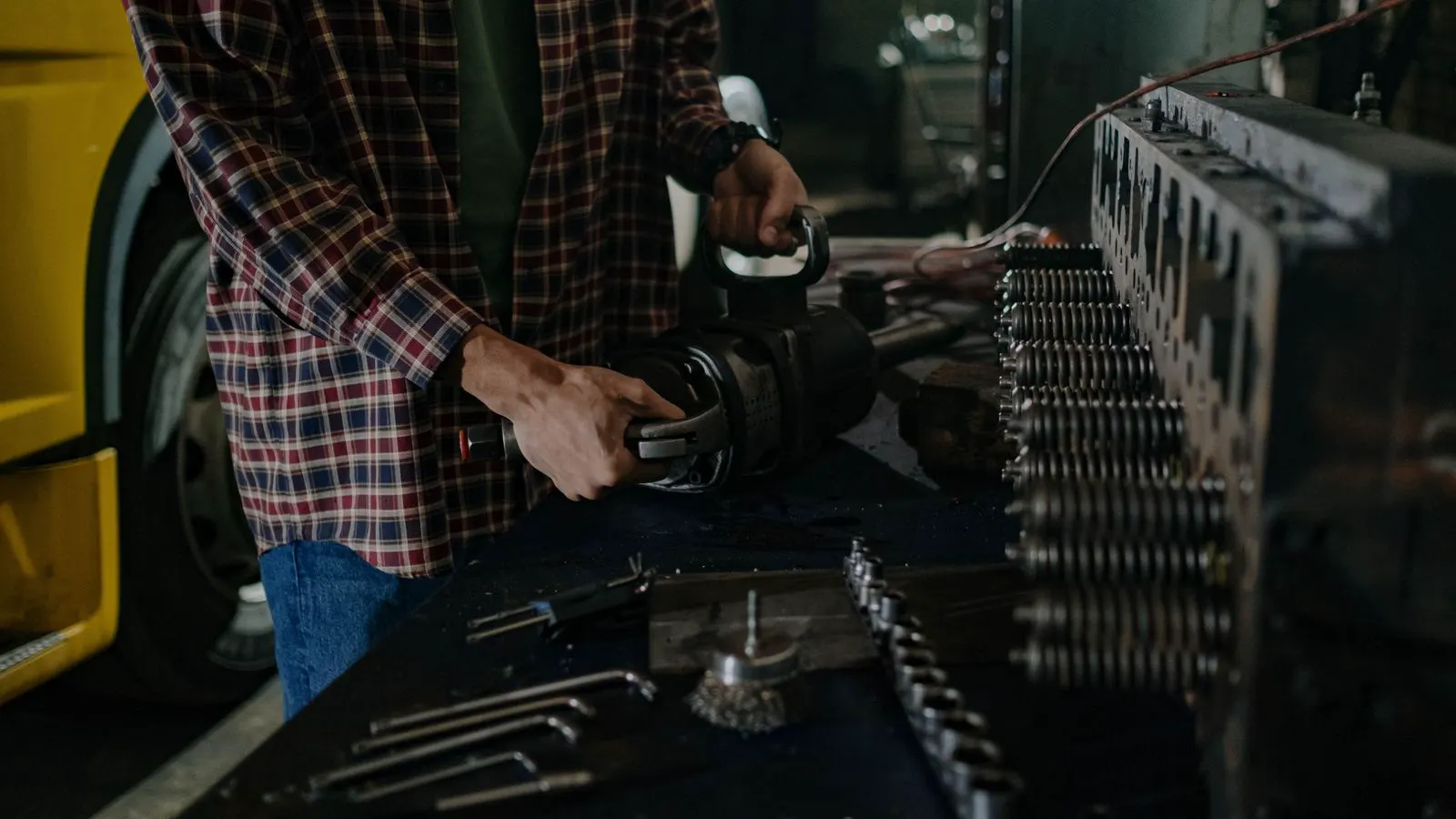 A technician inspects a metal stamping die with a digital sensor