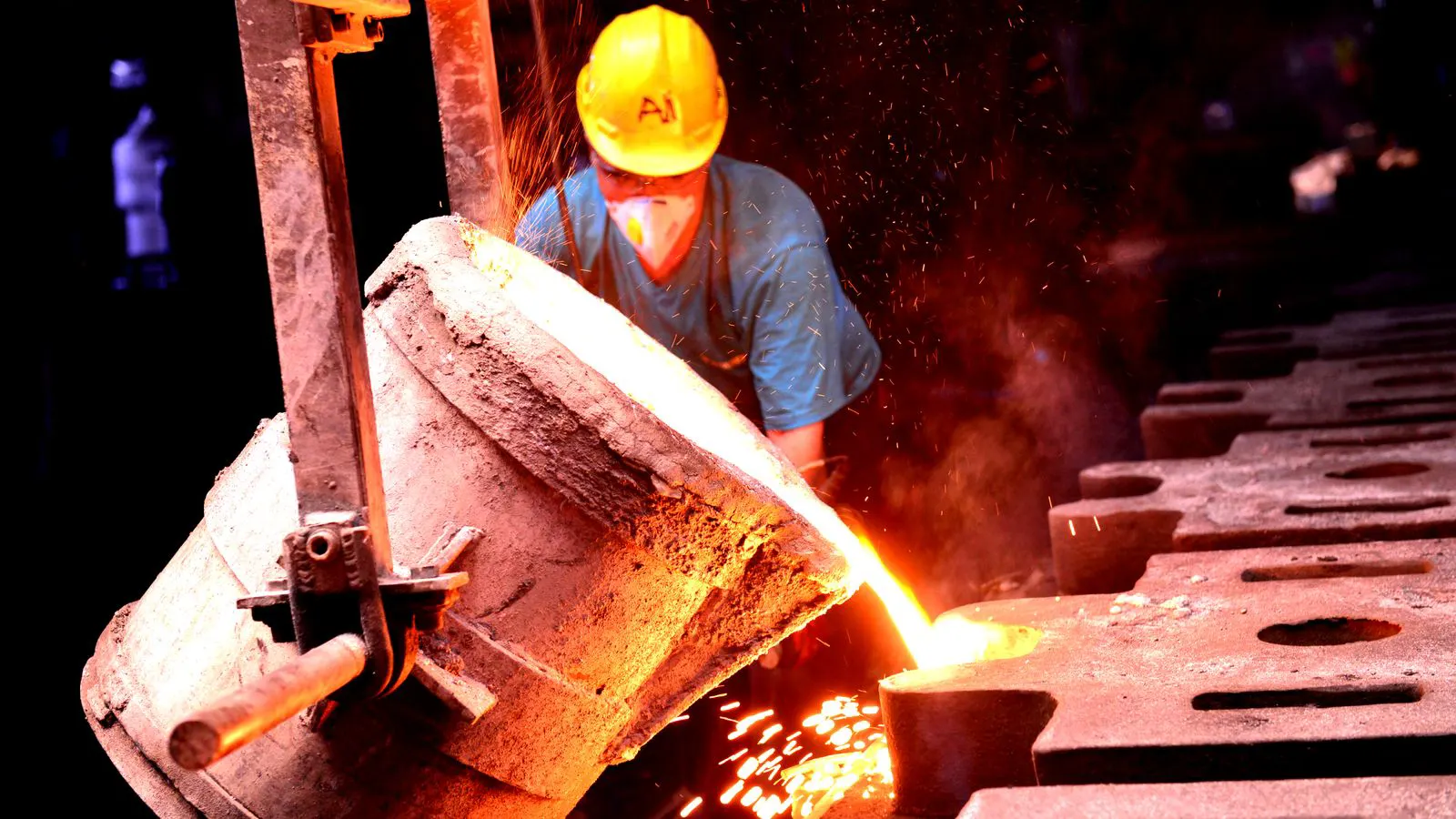 Steel ingots stacked in an industrial production facility.