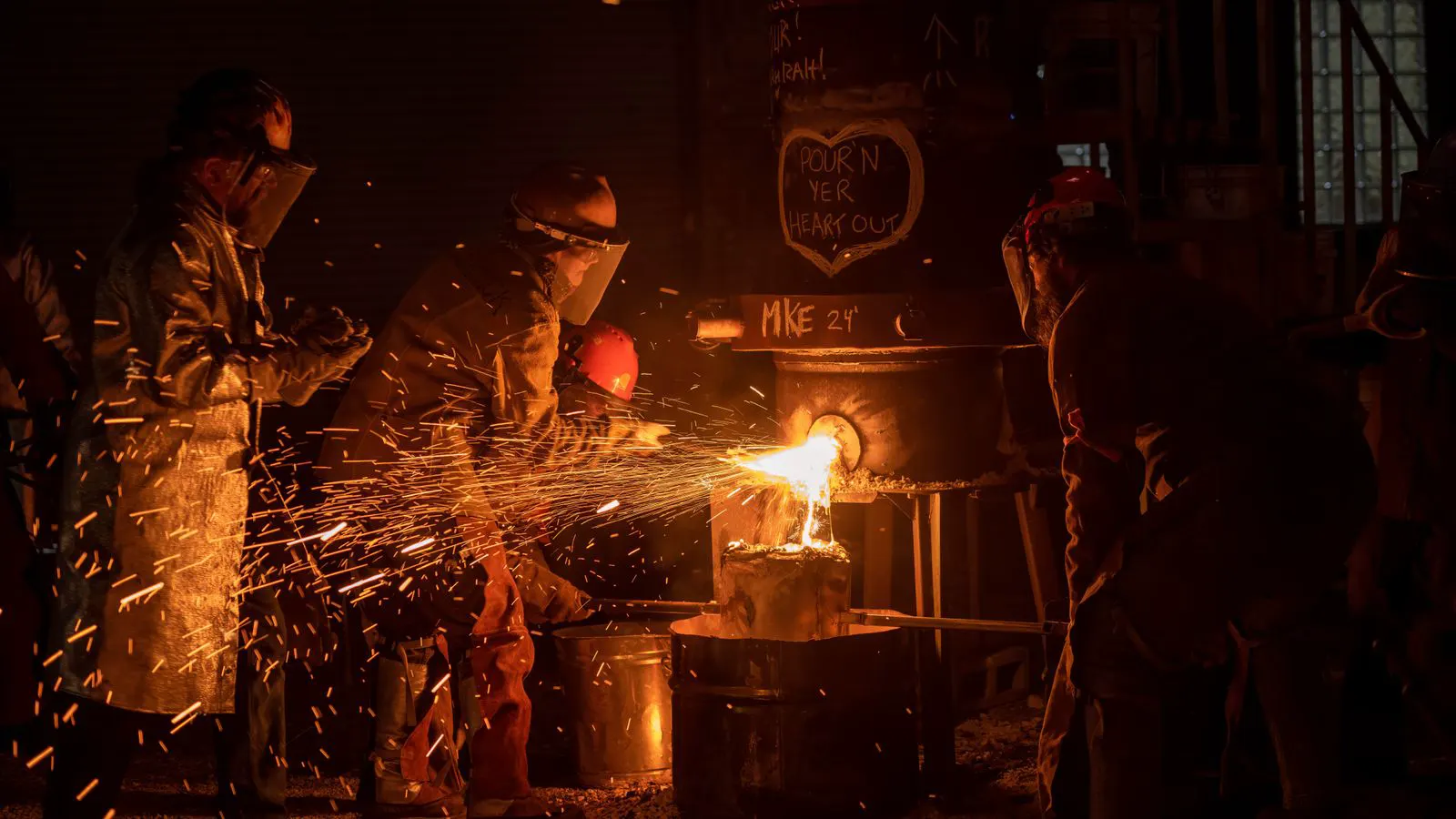 Two forged alloy steel shafts side by side on a workshop bench