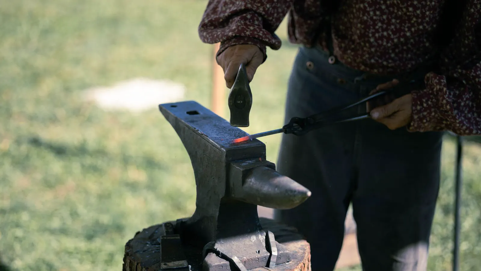 Industrial forging press shaping a metal billet