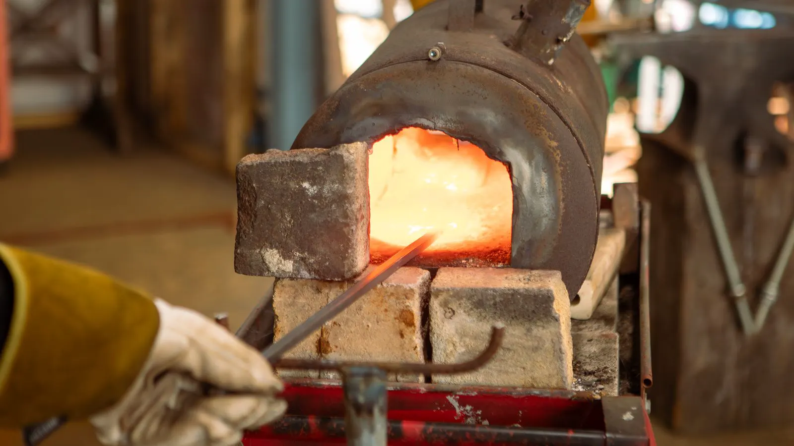 A metal forging die resting on a machine tool in a workshop