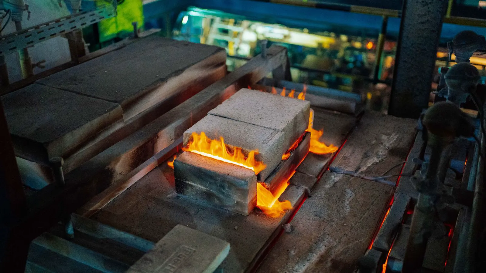 Industrial furnace door open with glowing metal inside