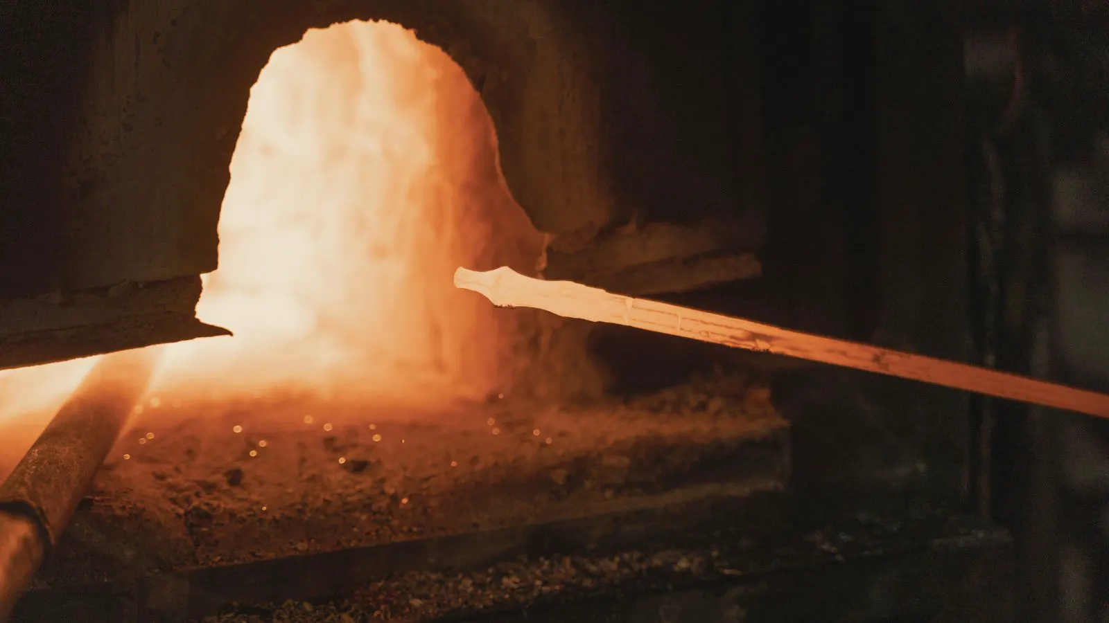A machinist using a portable hardness tester on a forged steel part.
