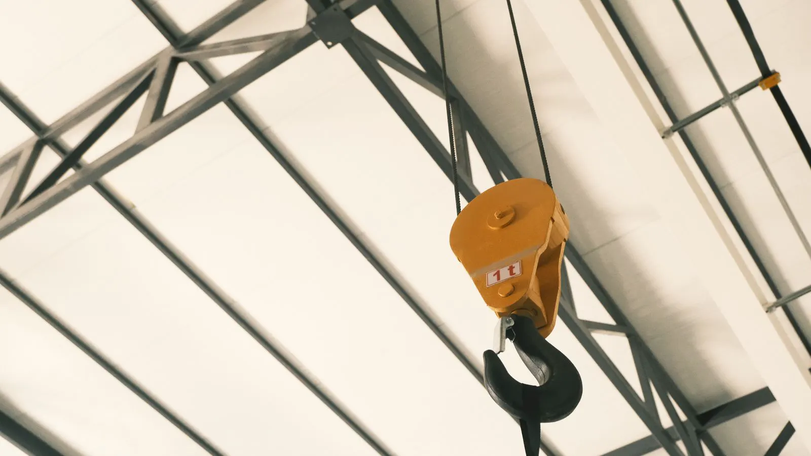 Close up of a heavy steel crane hook showing surface texture
