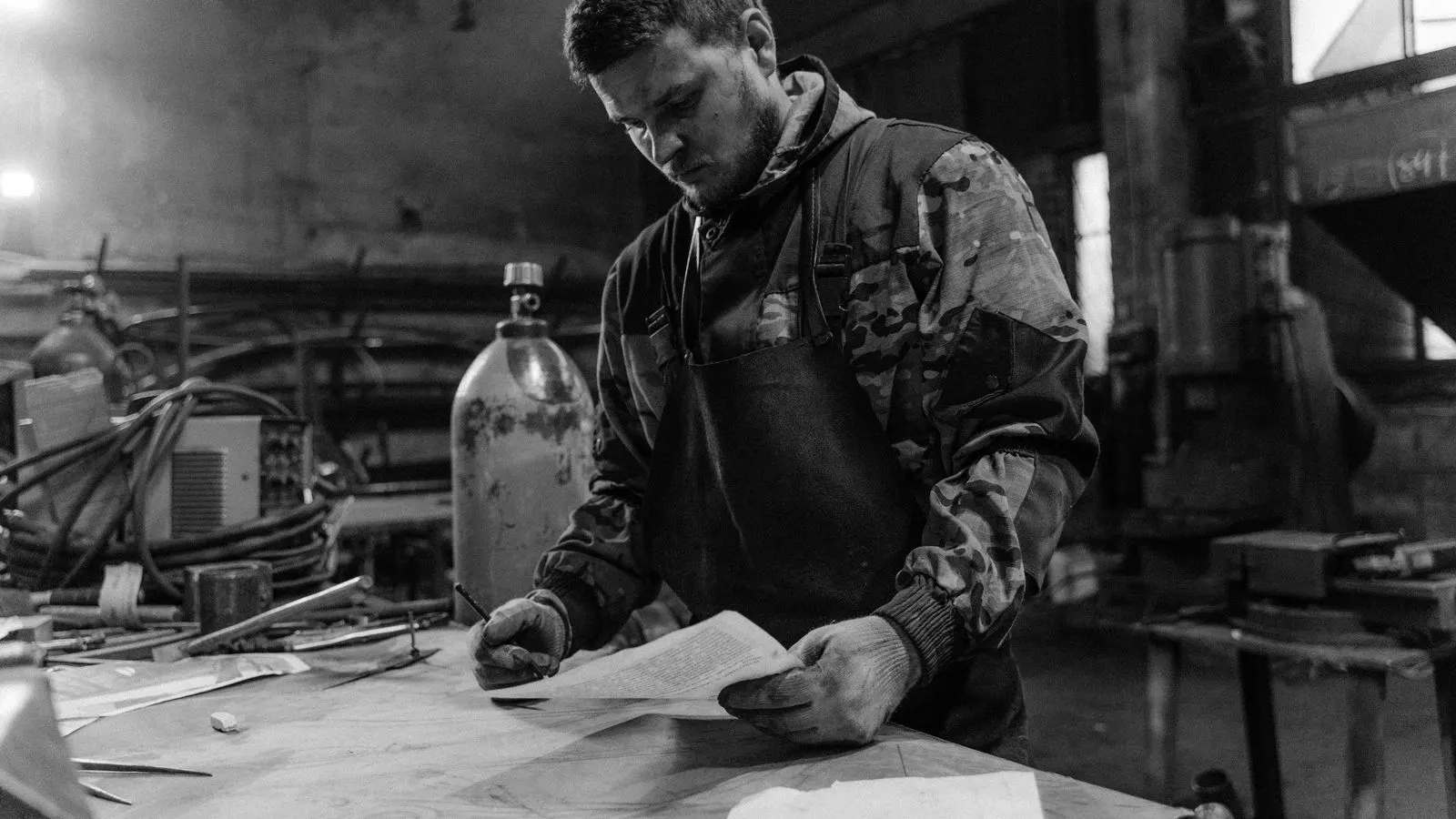 Engineer reviewing a forging mill certificate and NDT report on a workbench
