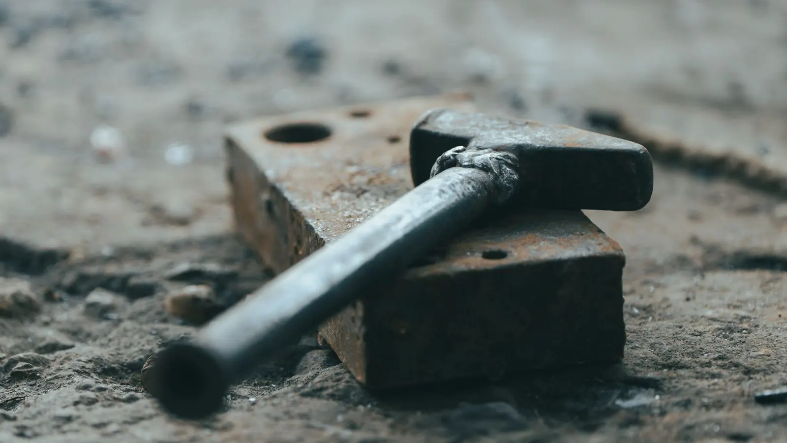 Heavy forging hammer striking a metal billet on a production floor