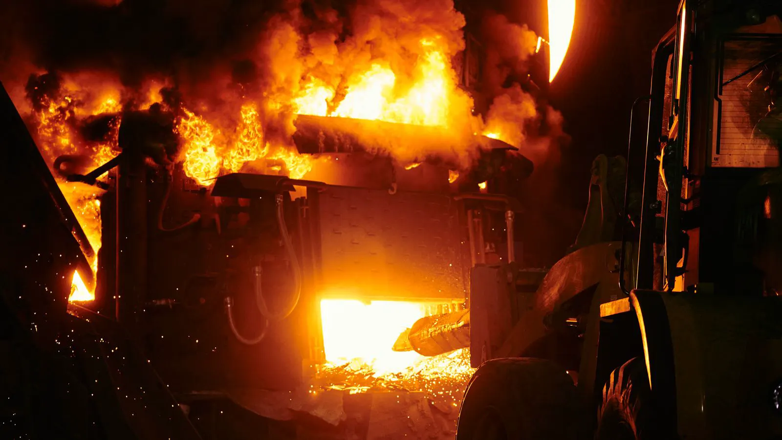 molten metal glowing inside a large industrial furnace